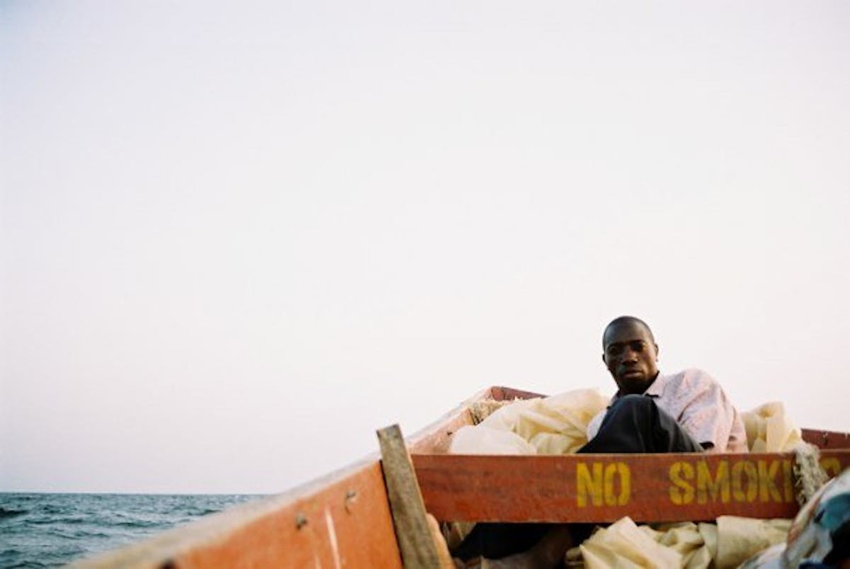 a man on a boat in lake victoria