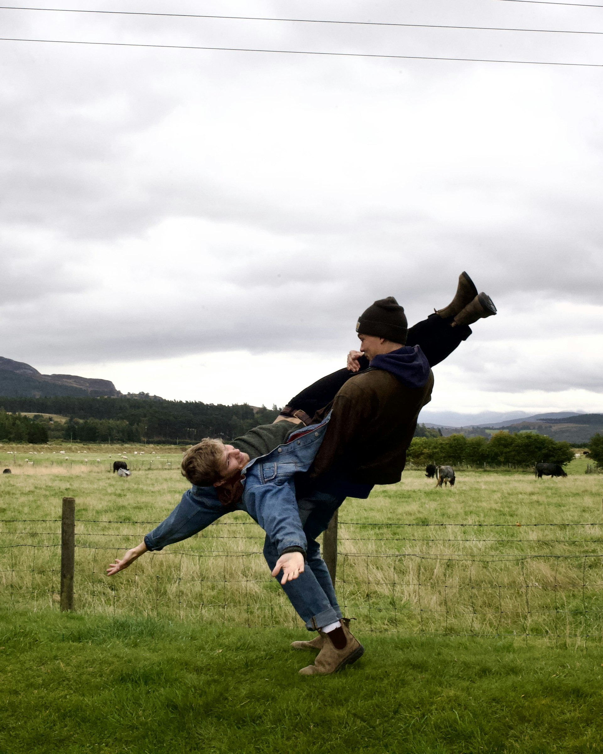 Jesse holding Allister upside down