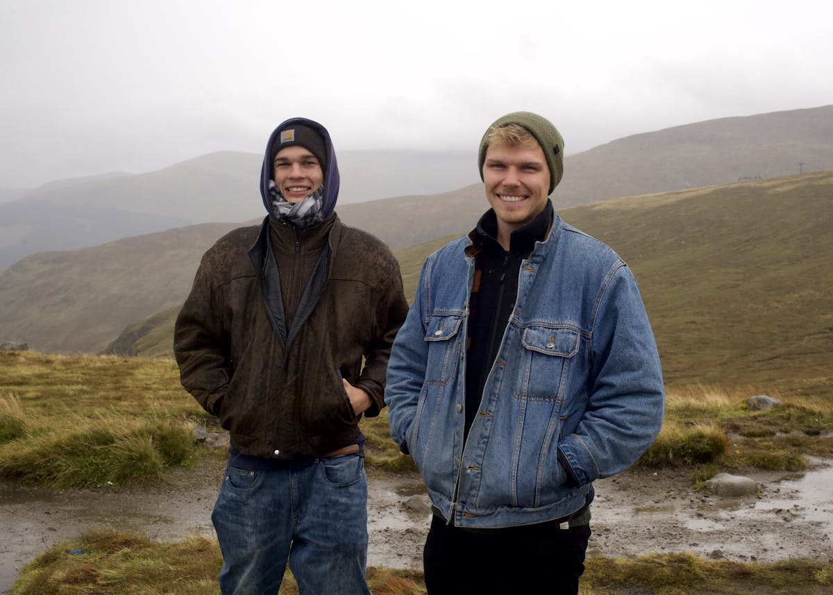 Allister and Jesse standing on Aonach Mor, with highlands in the background