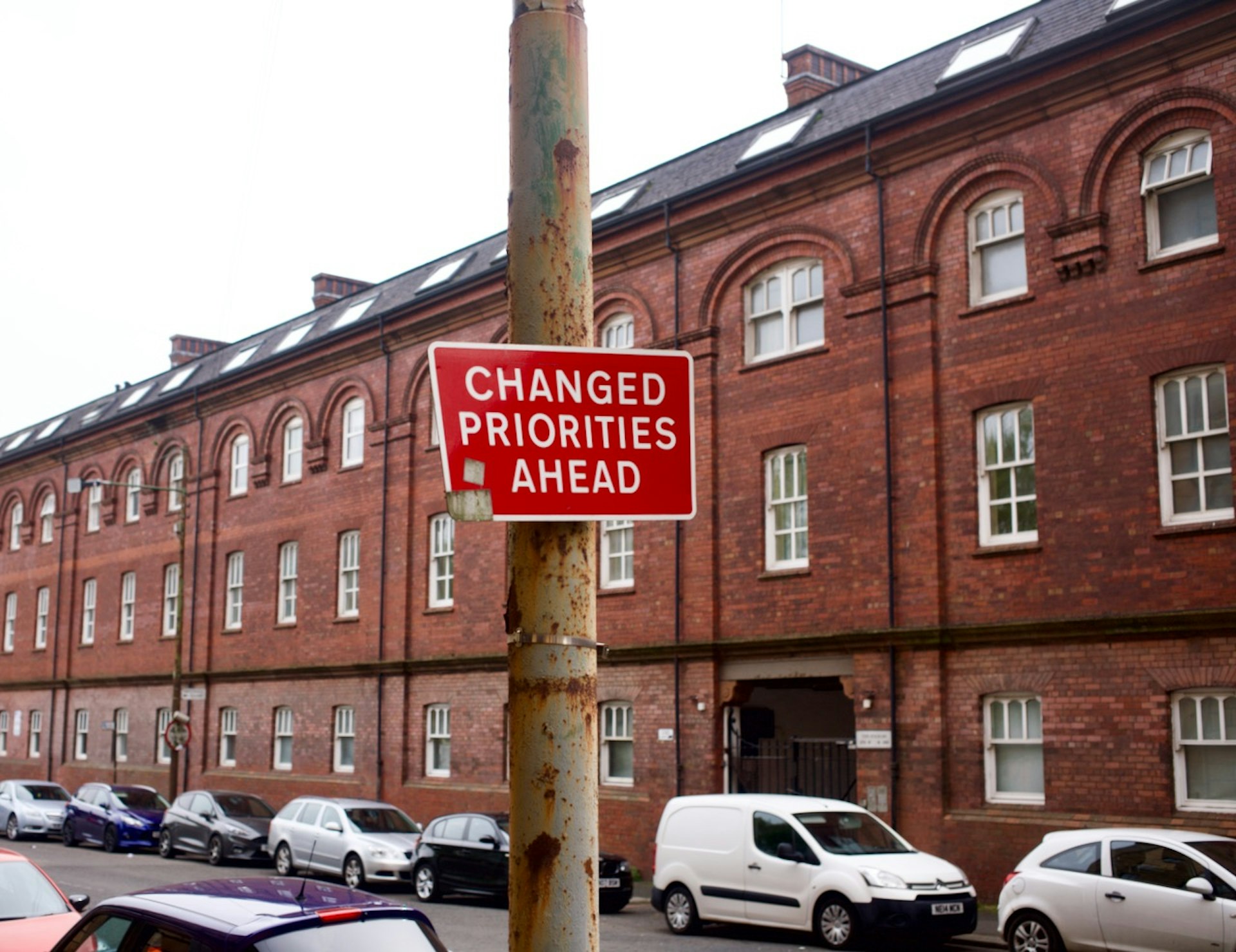A sign reads Changed Priorities Ahead