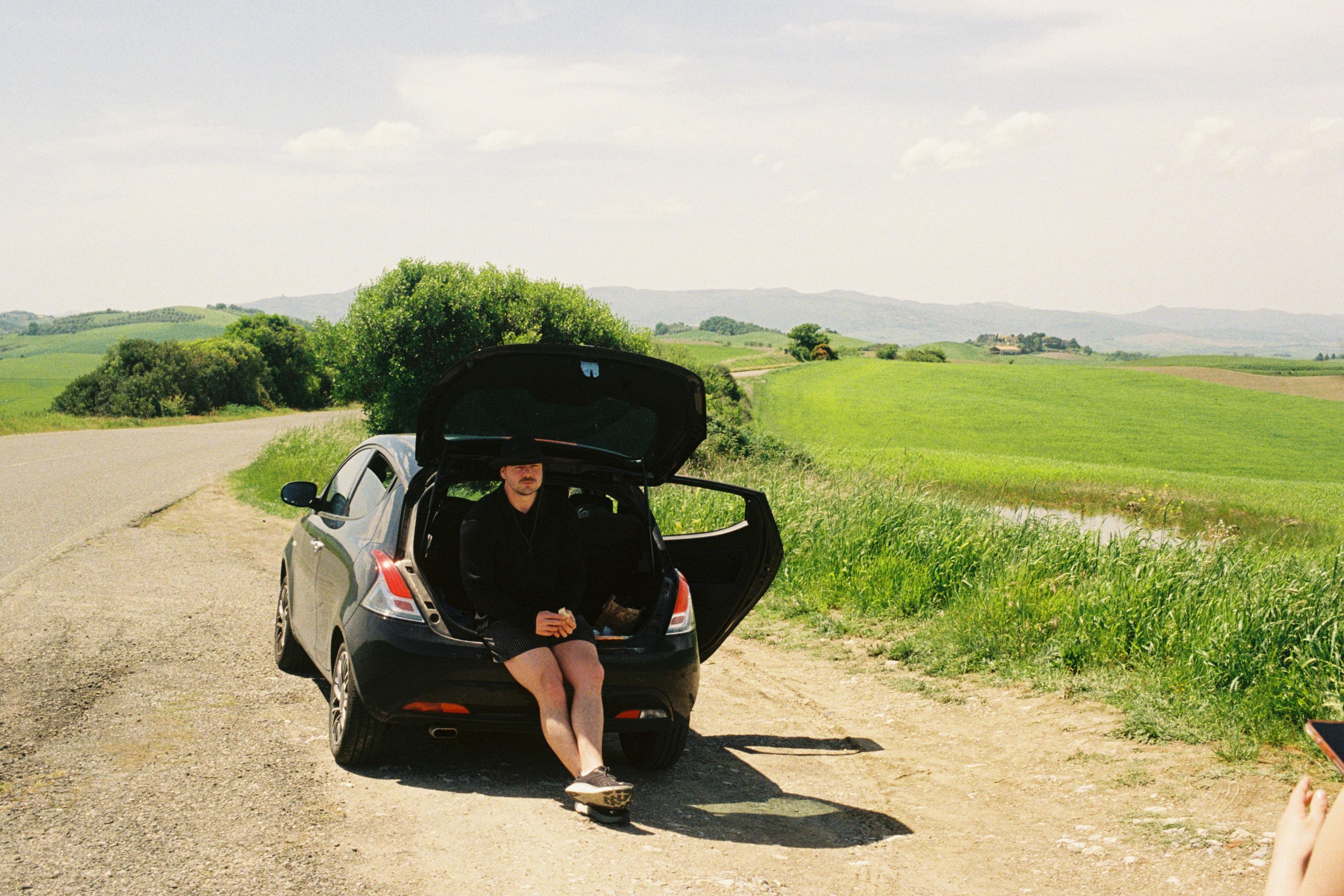 Leo sitting in a car on a roadtrip