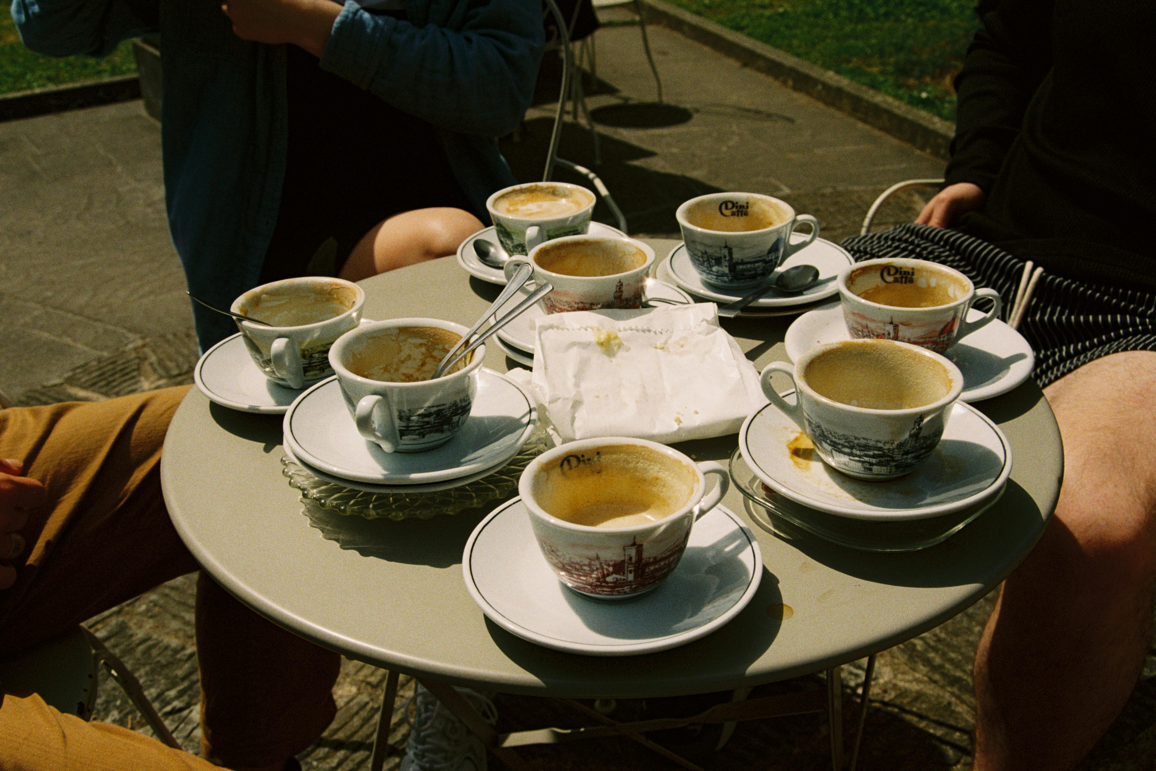 A table full of empty cappuccino cups