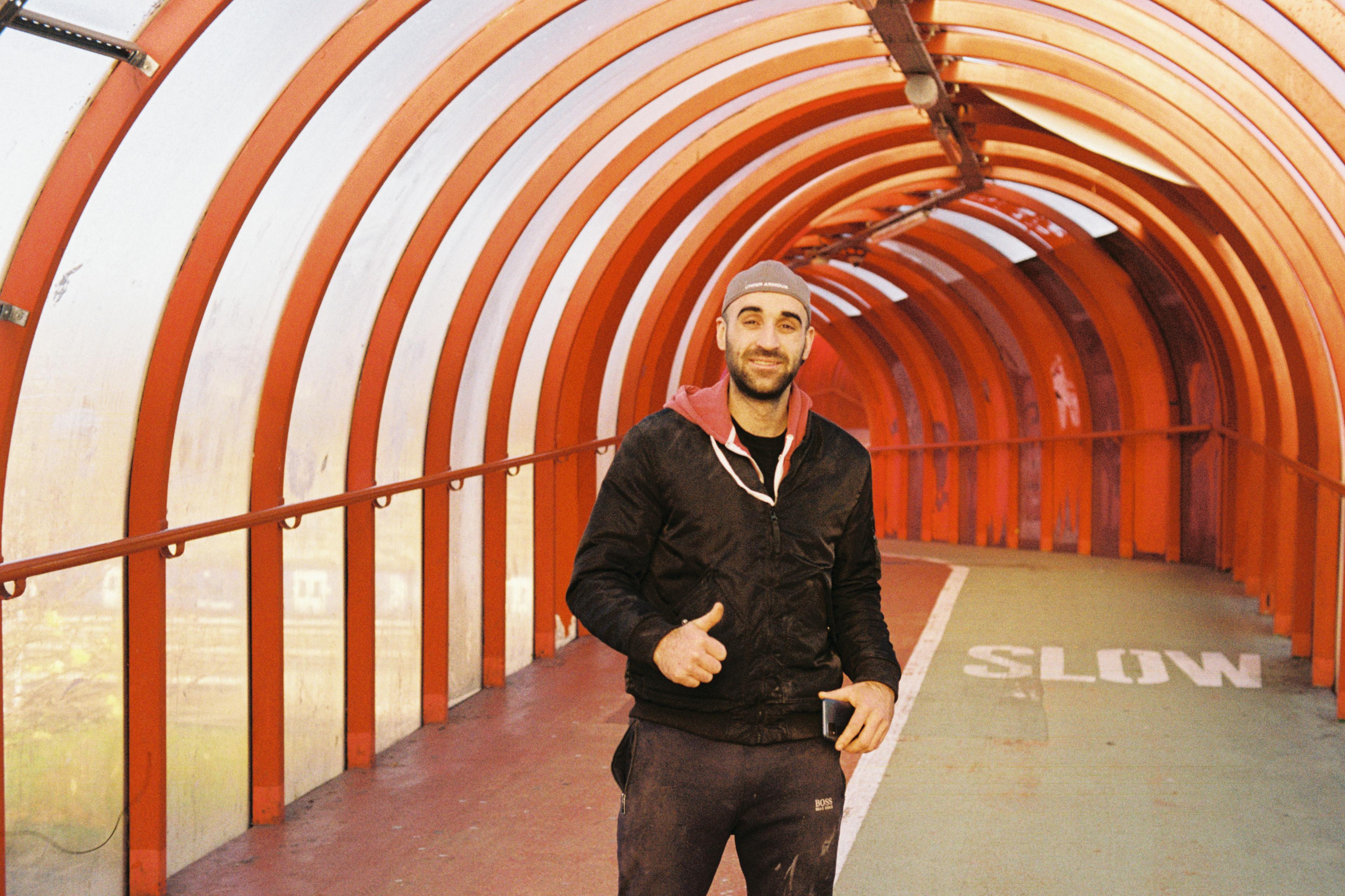 A man in a pedestrian tunnel