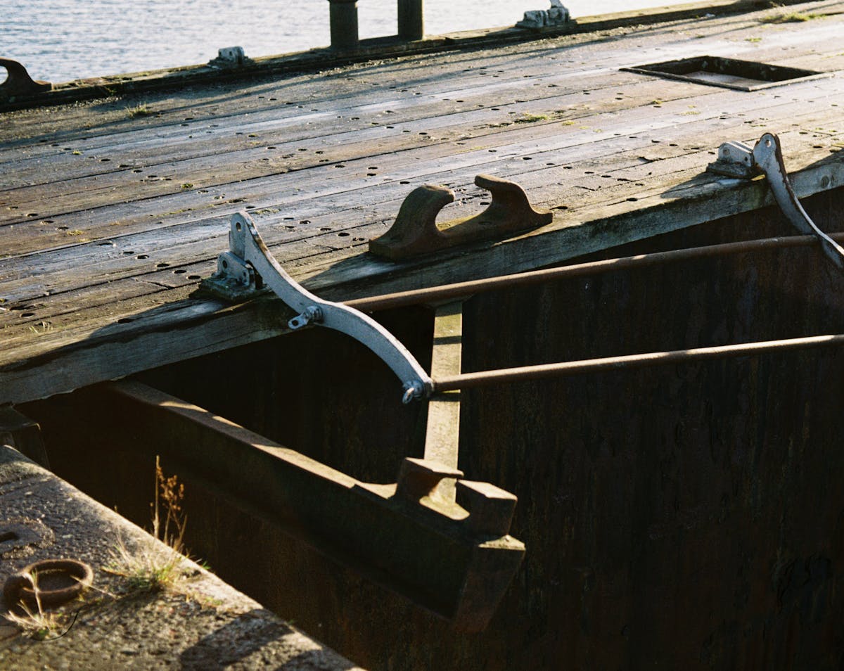 A toppled guardrail on a wooden footbridge