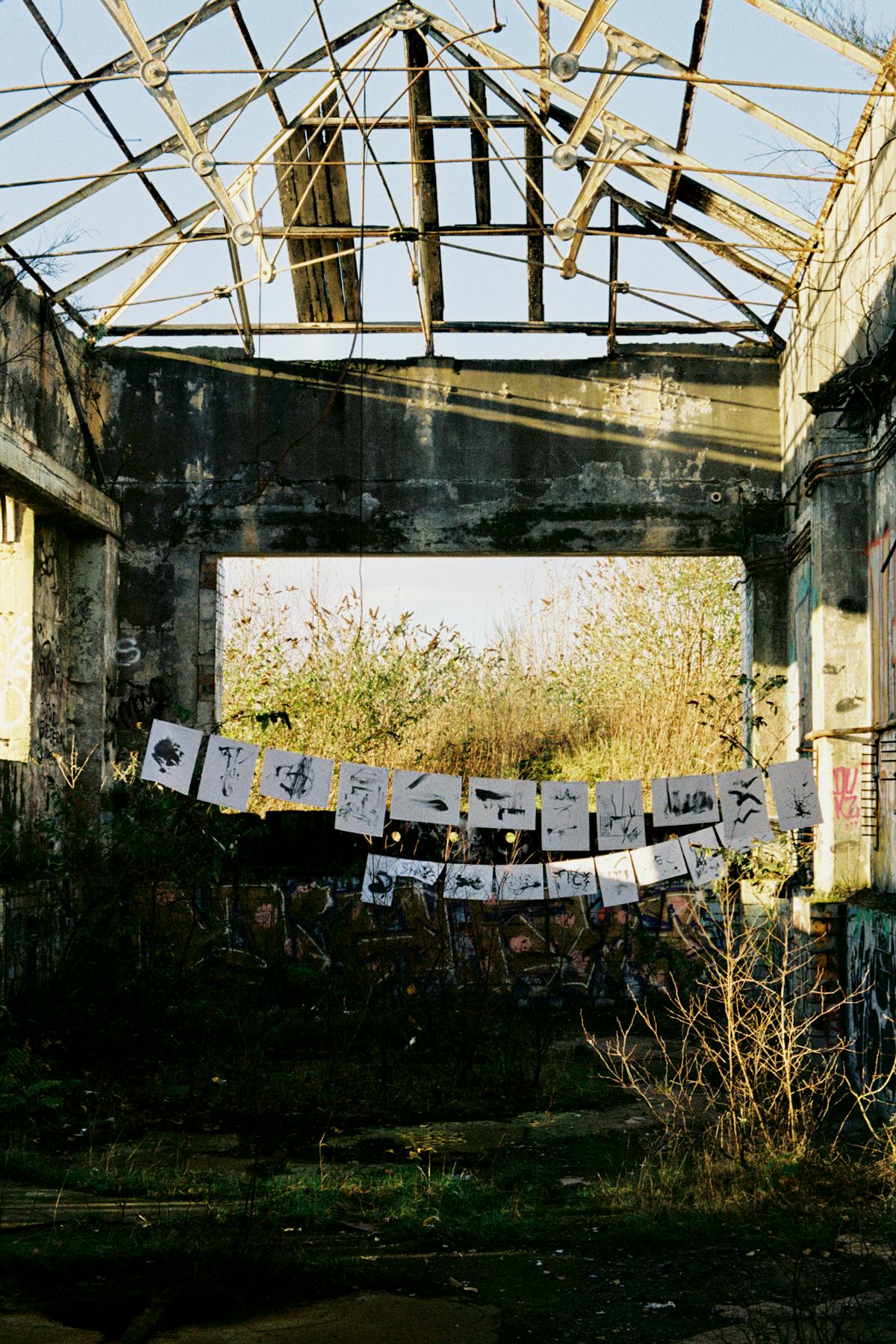 Posters with abstract art hanging in an abandoned building