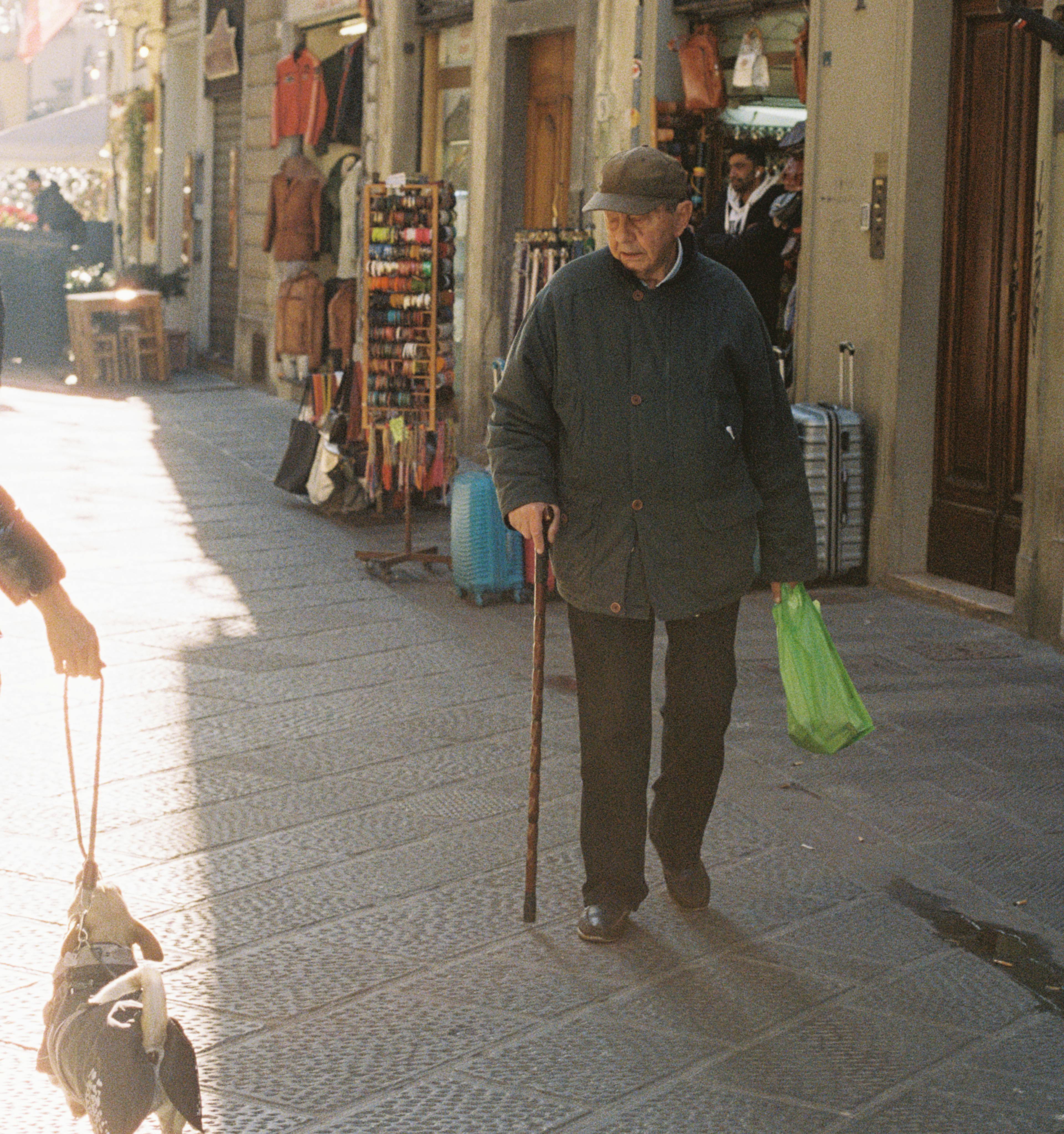 An old man looking at a dog