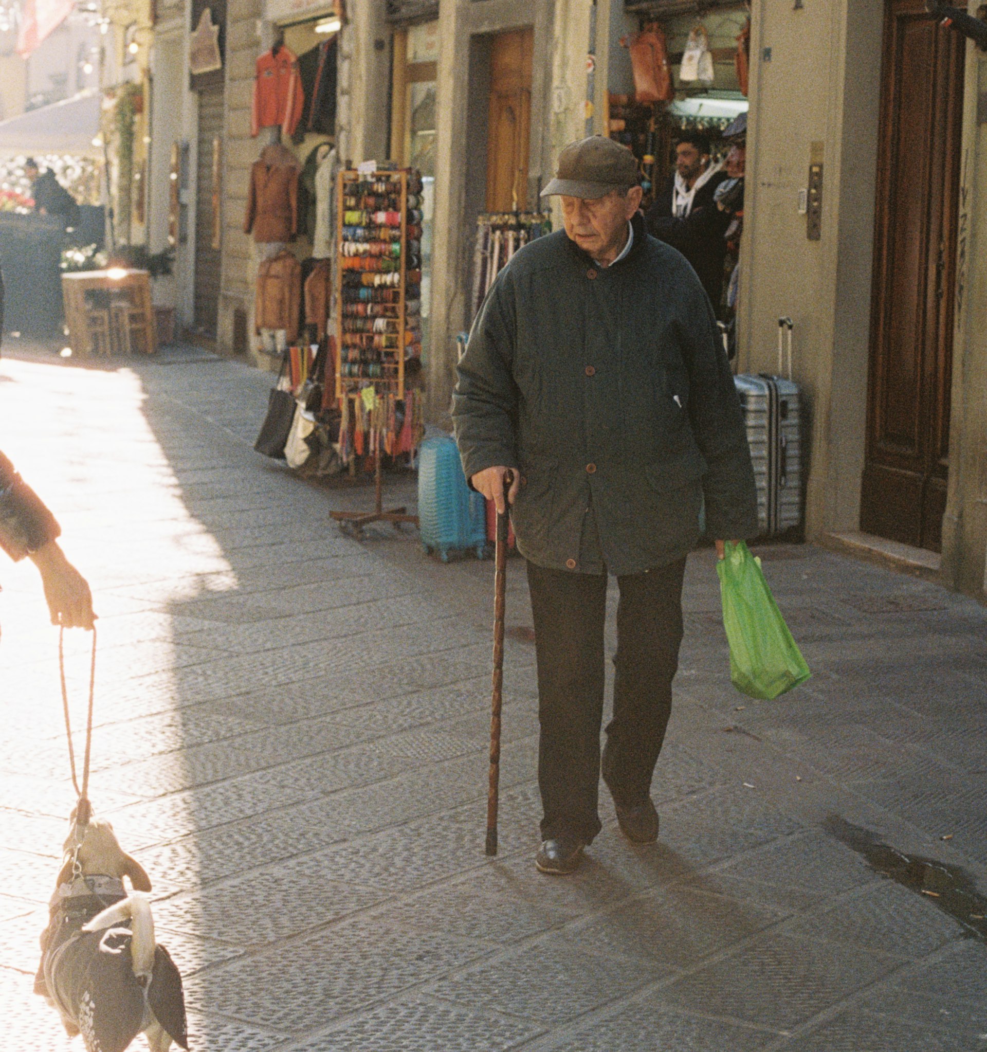 An old man looking at a dog