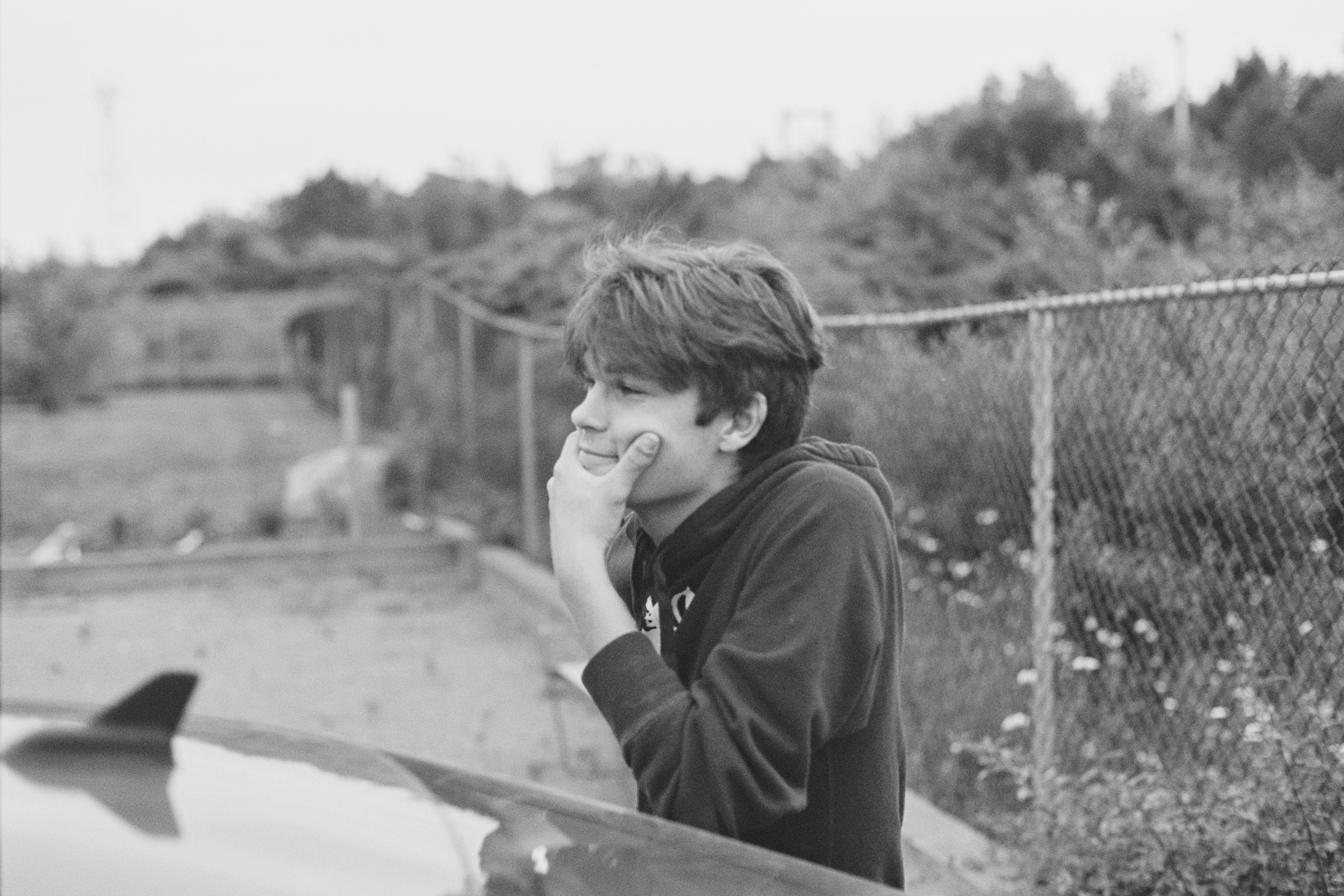 Jesse leaning on a car