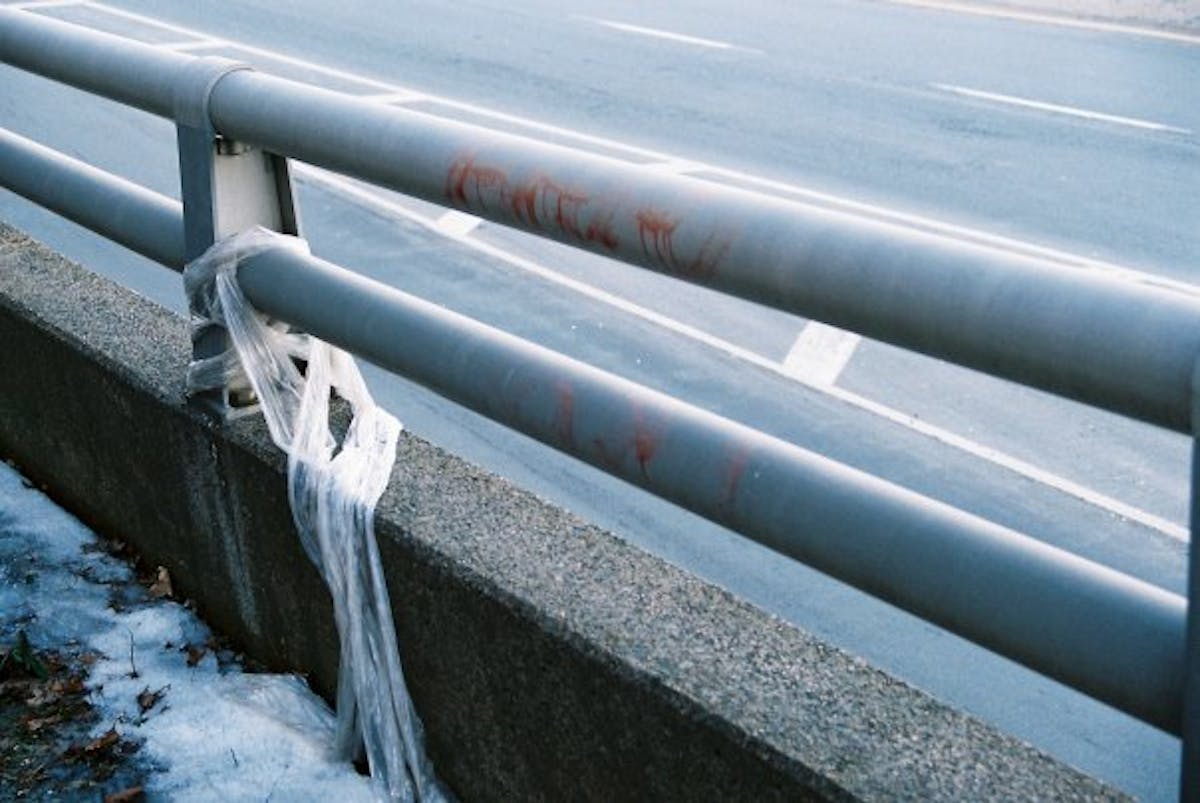 A piece of plastic wrapped around a highway guardrail