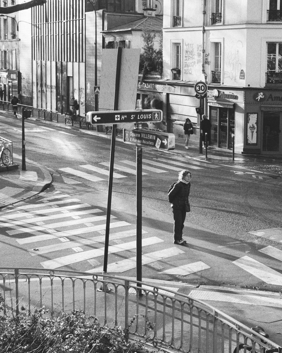 A woman standing in an intersection.