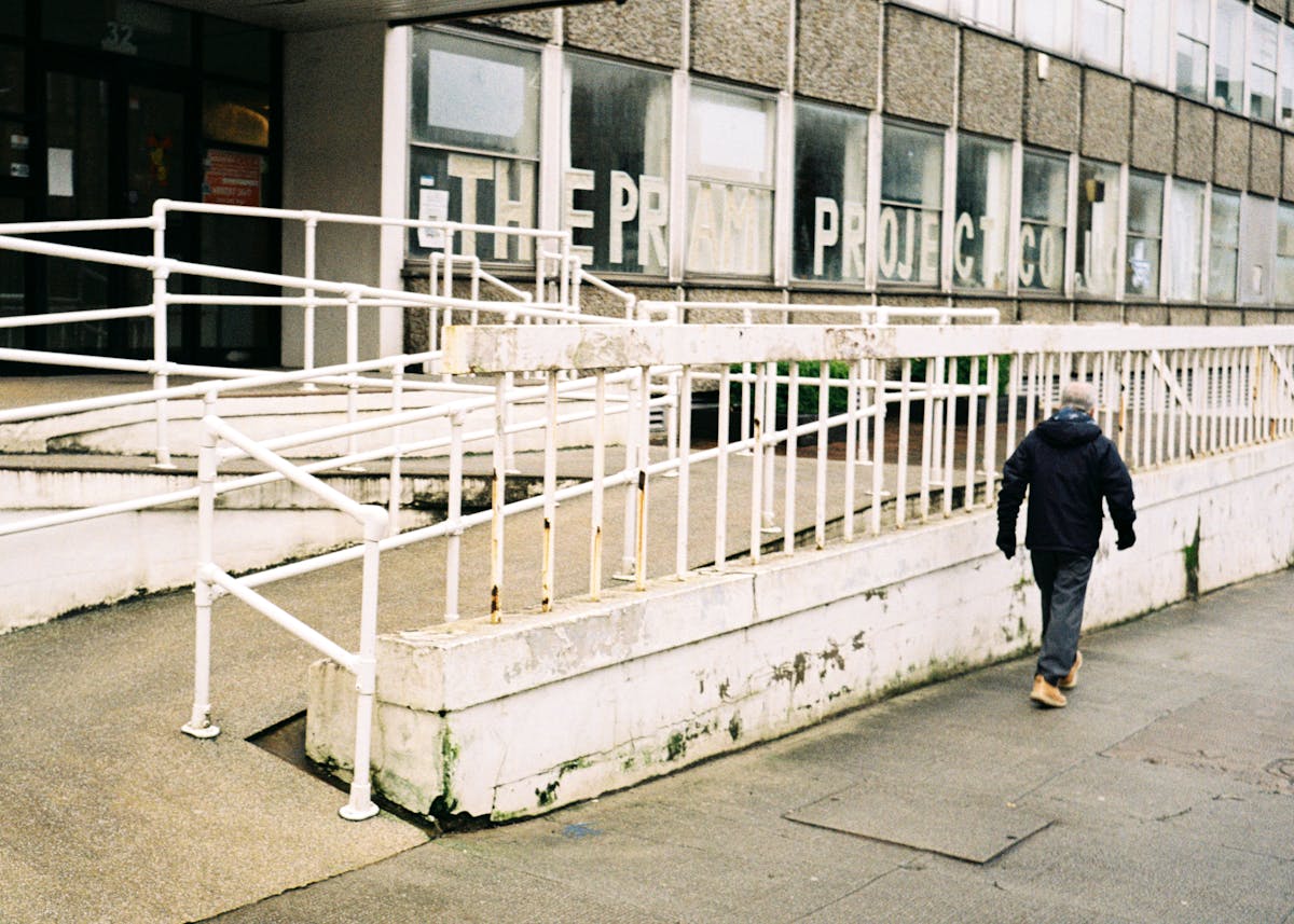 A man walking past a building