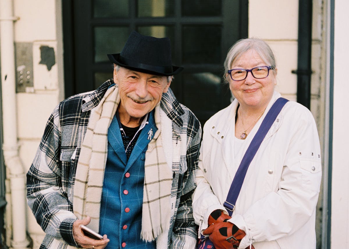 An old couple standing in a doorway