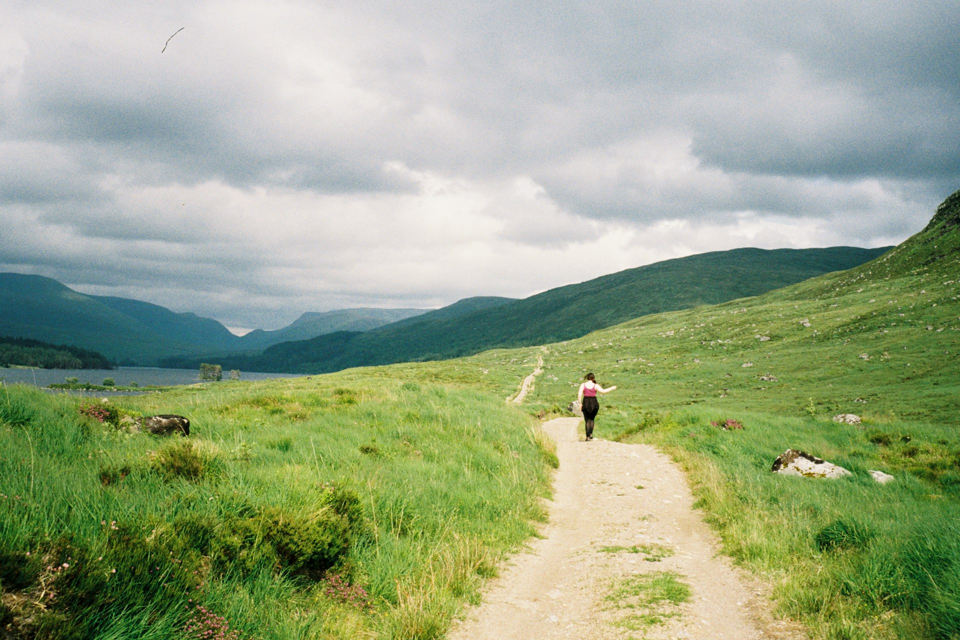 Claire hiking on a gravel path uphill