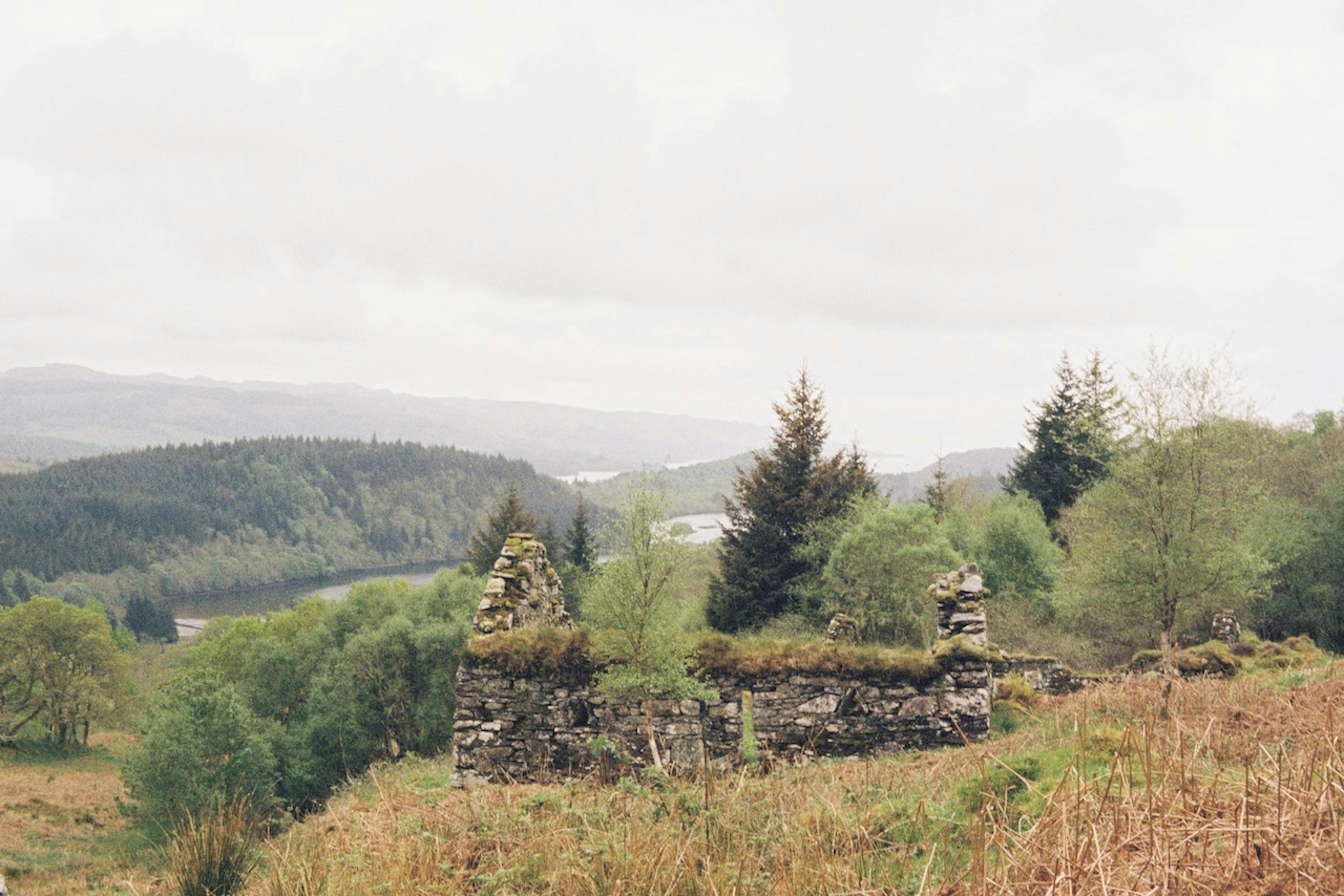 An abandoned house on a hillside.
